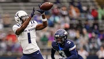 Utah State Aggies wide receiver Jalen Royals (1) makes the catch against UConn Huskies defensive back D'Mon Brinson (3) in the second quarter at Rentschler Field at Pratt & Whitney Stadium. 