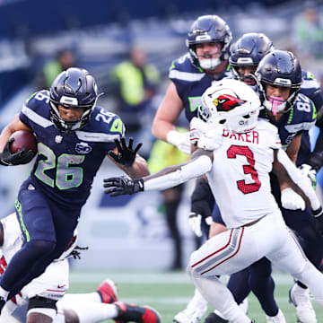 Nov 9, 2025; Seattle, Washington, USA; Seattle Seahawks running back Zach Charbonnet (26) rushes during the fourth quarter against the Arizona Cardinals at Lumen Field. Mandatory Credit: Kevin Ng-Imagn Images