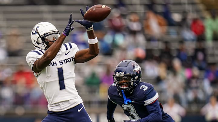 Utah State Aggies wide receiver Jalen Royals (1) makes the catch against UConn Huskies defensive back D'Mon Brinson (3) in the second quarter at Rentschler Field at Pratt & Whitney Stadium. Utah State Aggies wide receiver Jalen Royals (1) makes the catch against UConn Huskies defensive back D'Mon Brinson (3) in the second quarter at Rentschler Field at Pratt & Whitney Stadium.