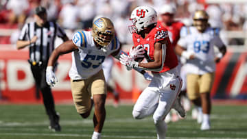Sep 23, 2023; Salt Lake City, Utah, USA; UCLA Bruins linebacker Darius Muasau (53) prepares to tackle Utah Utes wide receiver Devaughn Vele (17) in the second half at Rice-Eccles Stadium. Mandatory Credit: Rob Gray-Imagn Images
