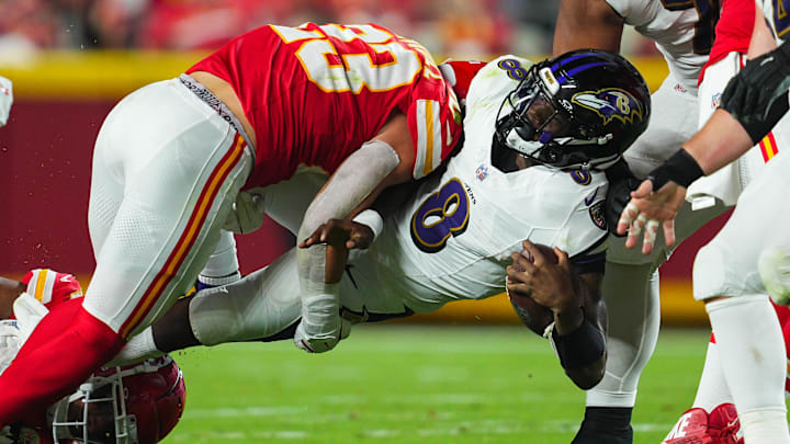 Baltimore Ravens quarterback Lamar Jackson (8) is tackled by Kansas City Chiefs linebacker Drue Tranquill (23) during the first half at GEHA Field at Arrowhead Stadium. 