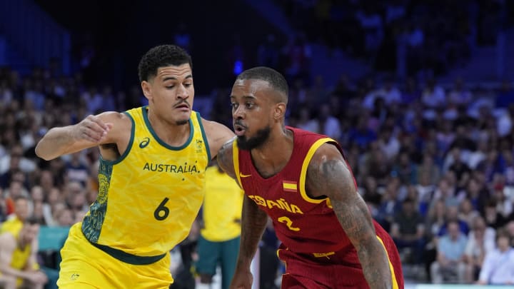 Jul 27, 2024; Villeneuve-d'Ascq, France; Spain guard Lorenzo Brown (2) drives past Australia small forward Josh Green (6) in men's Group A play during the Paris 2024 Olympic Summer Games at Stade Pierre-Mauroy. Mandatory Credit: John David Mercer-USA TODAY Sports