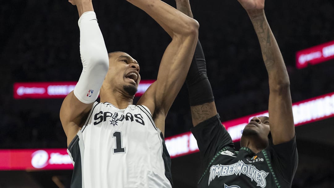 May 8, 2026; Minneapolis, Minnesota, USA; San Antonio Spurs forward Victor Wembanyama (1) drives past Minnesota Timberwolves forward Jaden McDaniels (3) in the first half during game three of the second round of the 2026 NBA Playoffs at Target Center. Mandatory Credit: Jesse Johnson-Imagn Images