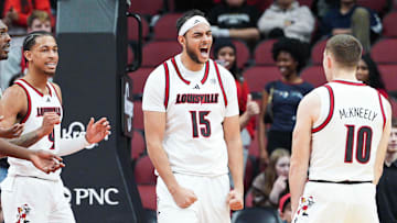Louisville Cardinals center Aly Khalifa (15) celebrates with Louisville Cardinals guard Isaac McKneely (10) as the Cards make a stop in the second half against Eastern Michigan Monday night, Nov. 24, 2025 at the KFC Yum! Center in Louisville, Kentucky.