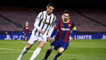 Cristiano Ronaldo (L) of Juventus FC is challenged by Lionel...
