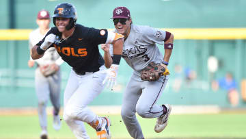 Texas A&M's Kaeden Kent (3) chases down Tennessee's Dean Curley (23) in between first and second base during game three of the NCAA College World Series finals between Tennessee and Texas A&M at Charles Schwab Field in Omaha, Neb., on Monday, June 24, 2024.