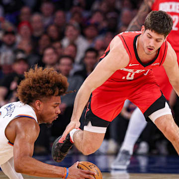 Feb 3, 2025; New York, New York, USA; New York Knicks guard Miles McBride (2) battles for a loose ball against Houston Rockets guard Reed Sheppard (15) during the first half at Madison Square Garden. Mandatory Credit: Vincent Carchietta-Imagn Images