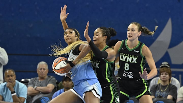 Jul 14, 2025; Chicago, Illinois, USA;  Chicago Sky forward Angel Reese (5) drives to the basket against Minnesota Lynx forward Alanna Smith (8) and forward Napheesa Collier (24) defends against Minnesota Lynx forward Jessica Shepard (15) during the first half at Wintrust Arena. Mandatory Credit: Matt Marton-Imagn Images