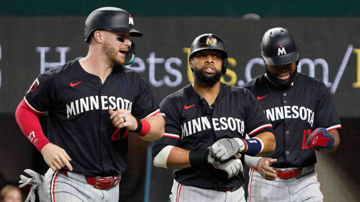 Aug 16, 2024; Arlington, Texas, USA; Minnesota Twins catcher Ryan Jeffers (27), first baseman Carlos Santana (30) and outfielder Manuel Margot (13) head the dugout after scoring on Santana’s three-run home run during the fifth inning against the Texas Rangers at Globe Life Field. Mandatory Credit: Raymond Carlin III-USA TODAY Sports