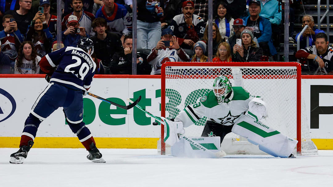 Mar 18, 2026; Denver, Colorado, USA; Colorado Avalanche center Nathan MacKinnon (29) shoots the puck wide of the net against Dallas Stars goaltender Jake Oettinger (29) in the shootout at Ball Arena. Mandatory Credit: Isaiah J. Downing-Imagn Images