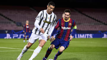 Cristiano Ronaldo (L) of Juventus FC is challenged by Lionel...