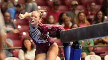 Apr 6, 2025; Tuscaloosa, AL, USA; Alabama's Rachel Rybicki celebrates after landing her beam dismount at Coleman Coliseum during the NCAA Gymnastics Tuscaloosa Regional. Florida won the event wtih a 197.700 and Alabama placed second to advance with a 197.675.