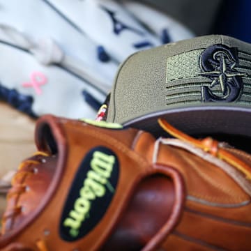 A Seattle Mariners Armed Forces Day hat is pictured in the dugout before a game against the Atlanta Braves on May 20, 2023, at Truist Park.