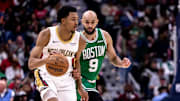 Jan 31, 2025; New Orleans, Louisiana, USA;  New Orleans Pelicans guard Trey Murphy III (25) dribbles against Boston Celtics guard Derrick White (9) during the second half at Smoothie King Center. Mandatory Credit: Stephen Lew-Imagn Images