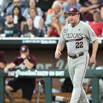 Jun 22, 2024; Omaha, NE, USA;  Texas A&M Aggies head coach Jim Schlossnagle walks to the mound against the Tennessee Volunteers during the fifth inning at Charles Schwab Field Omaha. Mandatory Credit: Steven Branscombe-USA TODAY Sports
