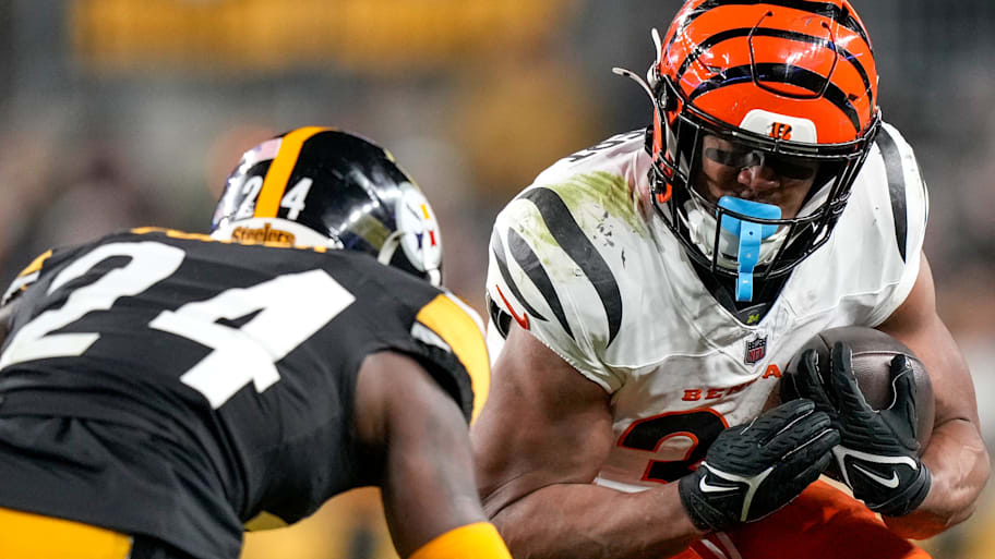 Cincinnati Bengals running back Khalil Herbert (34) is met by Pittsburgh Steelers cornerback Joey Porter Jr. (24) on a carry in the second quarter of the NFL Week 18 game between the Pittsburgh Steelers and the Cincinnati Bengals at Acrisure Stadium in Pittsburgh on Saturday, Jan. 4, 2025. | Sam Greene/The Enquirer / USA TODAY NETWORK via Imagn Images