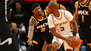 Dec 3, 2024; Phoenix, Arizona, USA; San Antonio Spurs guard Chris Paul (right) controls the ball against Phoenix Suns guard Bradley Beal in the second half of an NBA Cup game at Footprint Center.