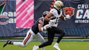 Oct 19, 2025; Chicago, Illinois, USA; New Orleans Saints wide receiver Chris Olave (12) runs with the ball after making a catch against Chicago Bears cornerback Kyler Gordon (6) during the first half at Soldier Field. Mandatory Credit: David Banks-Imagn Images