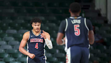 Nov 27, 2024; Paradise Island, Bahamas, BHS; Arizona Wildcats forward Trey Townsend (4) celebrates with Arizona Wildcats guard KJ Lewis (5) after scoring against the Davidson Wildcats during the first half at the Atlantis Resort.  Mandatory Credit: Kevin Jairaj-Imagn Images
