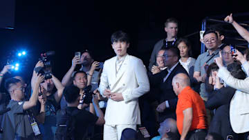 Jun 25, 2025; Yang Hansen makes his way to the stage after being selected as the 16th pick of the 2025 NBA Draft. Credit: Brad Penner-Imagn Images