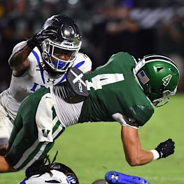 Venice wide receiver Ryan Matulevich gets caught between IMG Academy defensive backs Zech Fort (top) and Major Preston. Venice played host to IMG Academy on Friday, Oct. 4, 2024.