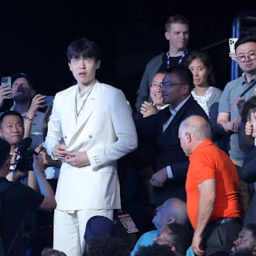 Jun 25, 2025; Brooklyn, NY, USA;  Yang Hansen walks to the stage after being selected as the 16th pick by the Memphis Grizzlies in the first round of the 2025 NBA Draft at Barclays Center.