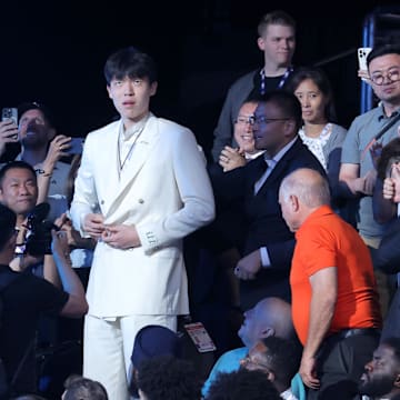 Jun 25, 2025; Brooklyn, NY, USA;  Yang Hansen walks to the stage after being selected as the 16th pick by the Memphis Grizzlies in the first round of the 2025 NBA Draft at Barclays Center. Mandatory Credit: Brad Penner-Imagn Images