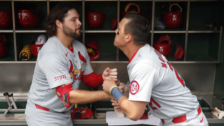 Jul 24, 2024; Pittsburgh, Pennsylvania, USA;  St. Louis Cardinals right fielder Alec Burleson (left) and left fielder Lars Nootbaar (21) perform a pre-game ritual before playing the Pittsburgh Pirates at PNC Park. Mandatory Credit: Charles LeClaire-USA TODAY Sports