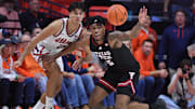 Nov 11, 2025; Champaign, Illinois, USA; Texas Tech Red Raiders forward JT Toppin (15) reaches for a loose ball in front of Illinois Fighting Illini guard Andrej Stojakovic (2) during the second half at State Farm Center.