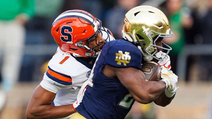 Notre Dame running back Jadarian Price, right, runs the ball into the end zone for a touchdown with Syracuse defensive back Demetres Samuel Jr. (1) attempting the tackled in the first half of a NCAA football game at Notre Dame Stadium on Saturday, Nov. 22, 2025, in South Bend.