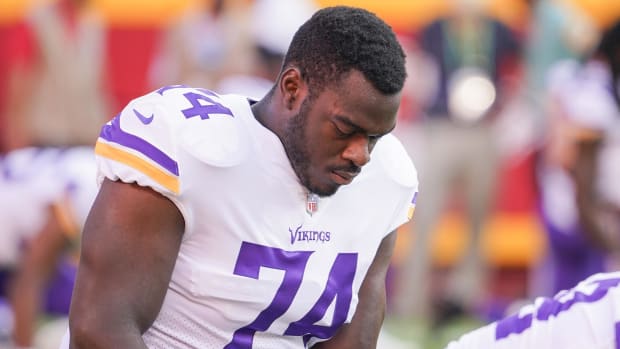 Minnesota Vikings offensive tackle Oli Udoh (74) stretches before the game.