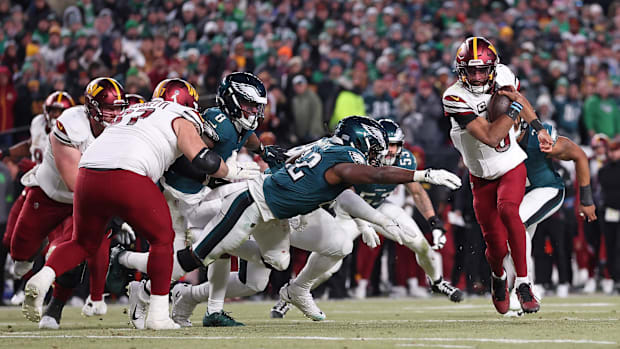 Jan 26, 2025; Philadelphia, PA, USA; Commanders' Jayden Daniels runs with the ball vs. Eagles during NFC Championship game.