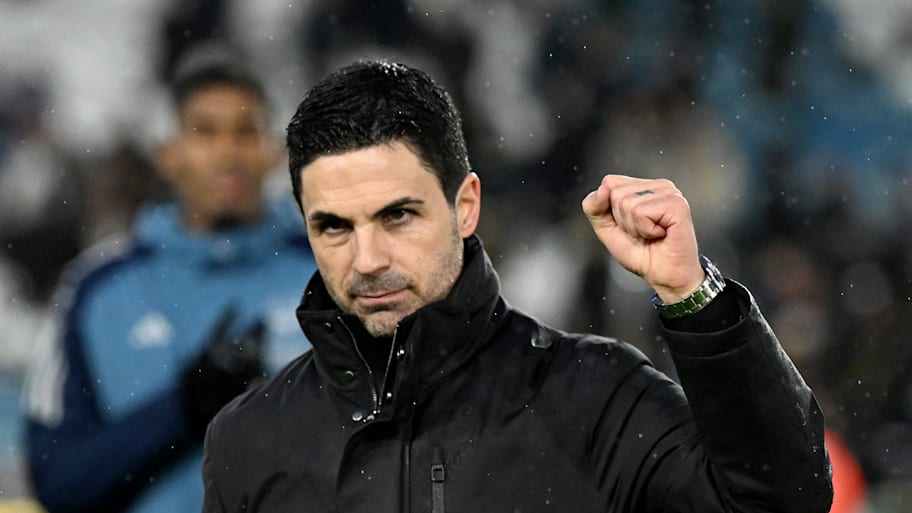 Mikel Arteta raising a clenched fist.