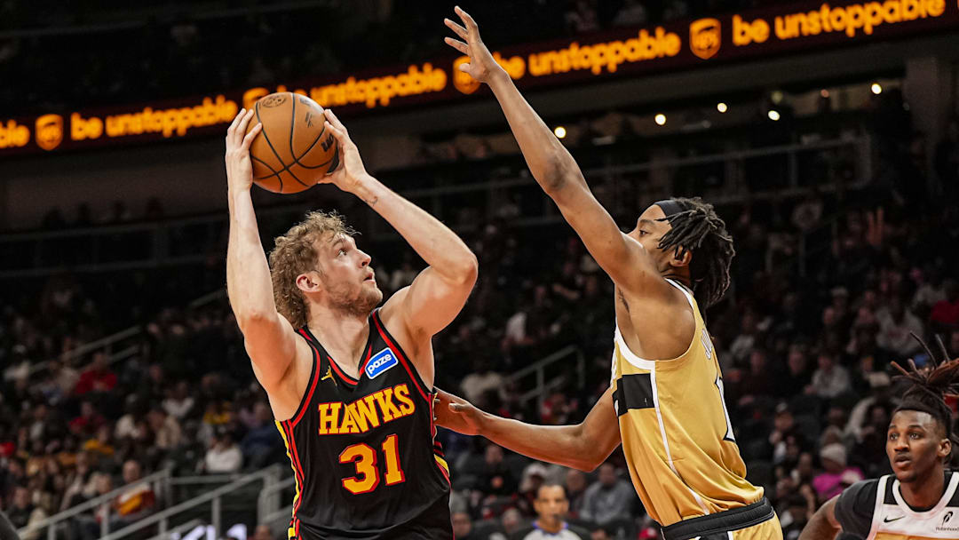 Feb 24, 2026; Atlanta, Georgia, USA; Atlanta Hawks center Jock Landale (31) shoots over Washington Wizards guard Tre Johnson (12) during the second half at State Farm Arena. Mandatory Credit: Dale Zanine-Imagn Images