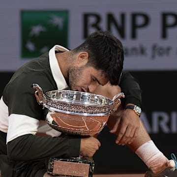 Jun 8, 2025; Paris, FR; Carlos Alcaraz of Spain poses with the trophy after winning the men’s singles final against Jannik Sinner