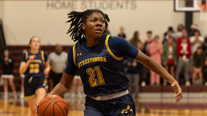 Streetsboro's Naomi Benson drives to the basket to score during Friday night   s game at Woodridge High School.