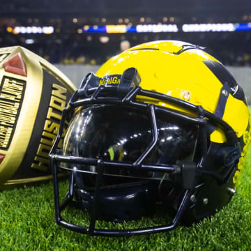 Jan 8, 2024; Houston, TX, USA; Detailed view of a Michigan Wolverines helmet and an oversized championship ring after defeating the Washington Huskies during the 2024 College Football Playoff national championship game at NRG Stadium. Mandatory Credit: Mark J. Rebilas-USA TODAY Sports