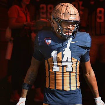 Oct 19, 2024; Champaign, Illinois, USA;  Illinois Fighting Illini defensive back Xavier Scott (14) steps into the light on the tunnel before the start of a game with the Michigan Wolverines at Memorial Stadium. Mandatory Credit: Ron Johnson-Imagn Images