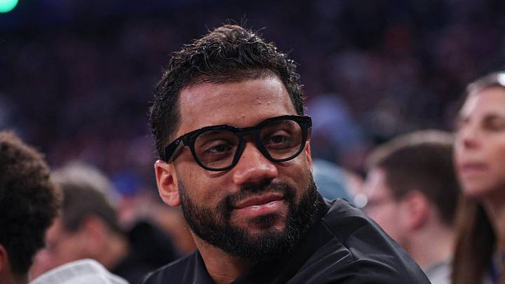 Former Seattle Seahawks quarterback, Russell Wilson, sits court-side