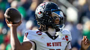Oct 11, 2025; South Bend, Indiana, USA; NC State Wolfpack quarterback CJ Bailey (11) throws a pass against the Notre Dame Fighting Irish during the first half at Notre Dame Stadium. Mandatory Credit: Michael Caterina-Imagn Images