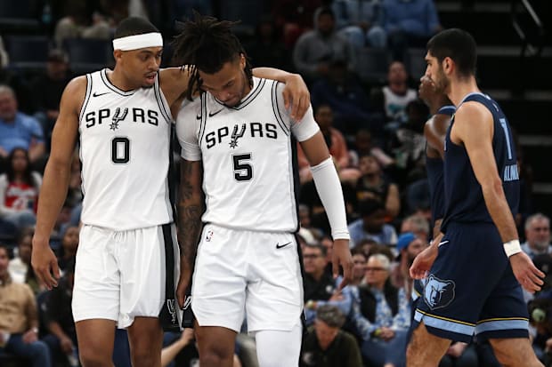 San Antonio Spurs forward Keldon Johnson (0) embraces guard Stephon Castle (5) during a time out  during the second quarter a