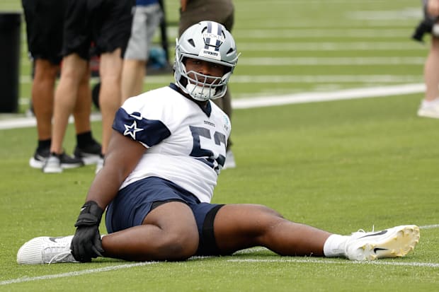 Dallas Cowboys guard Tyler Booker goes through a drill during practice at the Ford Center at the Star Training Facility Dallas Cowboys guard Tyler Booker goes through a drill during practice at the Ford Center at the Star Training Facility
