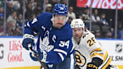 Nov 8, 2025; Toronto, Ontario, CAN;  Toronto Maple Leafs forward Auston Matthews (34) pursues the puck ahead of Boston Bruins defenseman Andrew Peeke (26) in the first period at Scotiabank Arena. Mandatory Credit: Dan Hamilton-Imagn Images