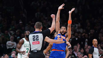May 5, 2025; Boston, Massachusetts, USA; New York Knicks center Karl-Anthony Towns (32) called for the foul against Boston Celtics forward Jayson Tatum (0) in the first quarter during game one of the second round for the 2025 NBA Playoffs at TD Garden. Mandatory Credit: David Butler II-Imagn Images