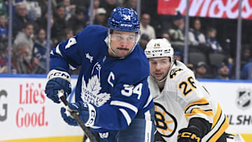 Nov 8, 2025; Toronto, Ontario, CAN;  Toronto Maple Leafs forward Auston Matthews (34) pursues the puck ahead of Boston Bruins defenseman Andrew Peeke (26) in the first period at Scotiabank Arena. Mandatory Credit: Dan Hamilton-Imagn Images