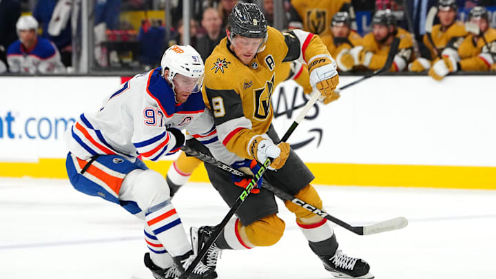 Dec 3, 2024; Las Vegas, Nevada, USA; Edmonton Oilers center Connor McDavid (97) defends against Vegas Golden Knights center Jack Eichel (9) during the second period at T-Mobile Arena. Mandatory Credit: Stephen R. Sylvanie-Imagn Images