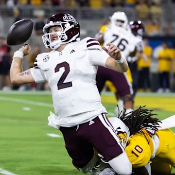 Sep 7, 2024; Tempe, Arizona, USA; Mississippi State Bulldogs quarterback Blake Shapen (2) fumbles the ball as he is tackled by Arizona State Sun Devils defensive lineman Clayton Smith (10) in the first half at Mountain America Stadium. Mandatory Credit: Mark J. Rebilas-Imagn Images