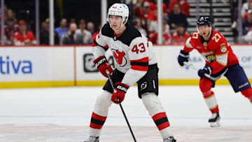 Nov 12, 2024; Sunrise, Florida, USA; New Jersey Devils defenseman Luke Hughes (43) moves the puck against the Florida Panthers during the first period at Amerant Bank Arena. Mandatory Credit: Sam Navarro-Imagn Images