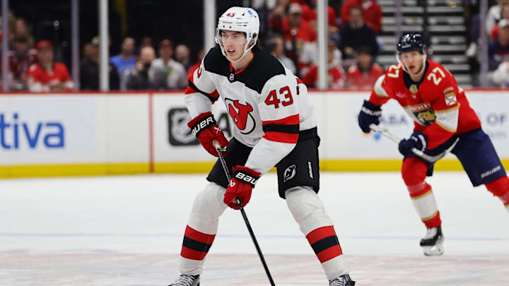 Nov 12, 2024; Sunrise, Florida, USA; New Jersey Devils defenseman Luke Hughes (43) moves the puck against the Florida Panthers during the first period at Amerant Bank Arena. Mandatory Credit: Sam Navarro-Imagn Images