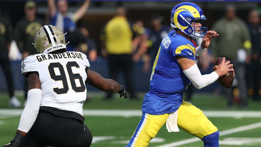Nov 2, 2025; Inglewood, California, USA; Los Angeles Rams quarterback Matthew Stafford (9) steps up in the pocket as New Orleans Saints defensive end Carl Granderson (96) applies pressure during the first half at SoFi Stadium. Mandatory Credit: Kiyoshi Mio-Imagn Images